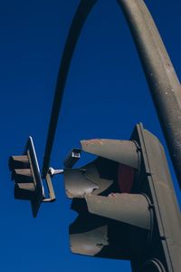 Low angle view of traffic against blue sky