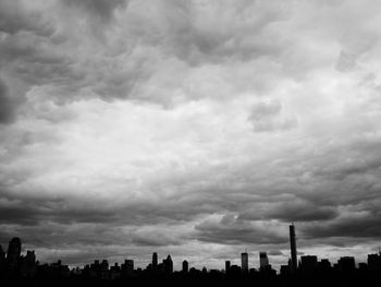 Cityscape against cloudy sky