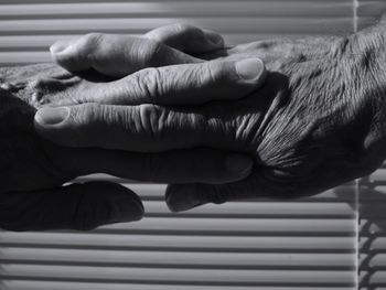 Cropped image of hands clasped