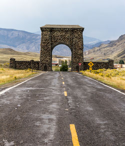 Road leading towards mountain against sky