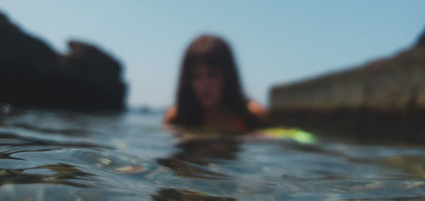 Rear view of woman swimming in lake
