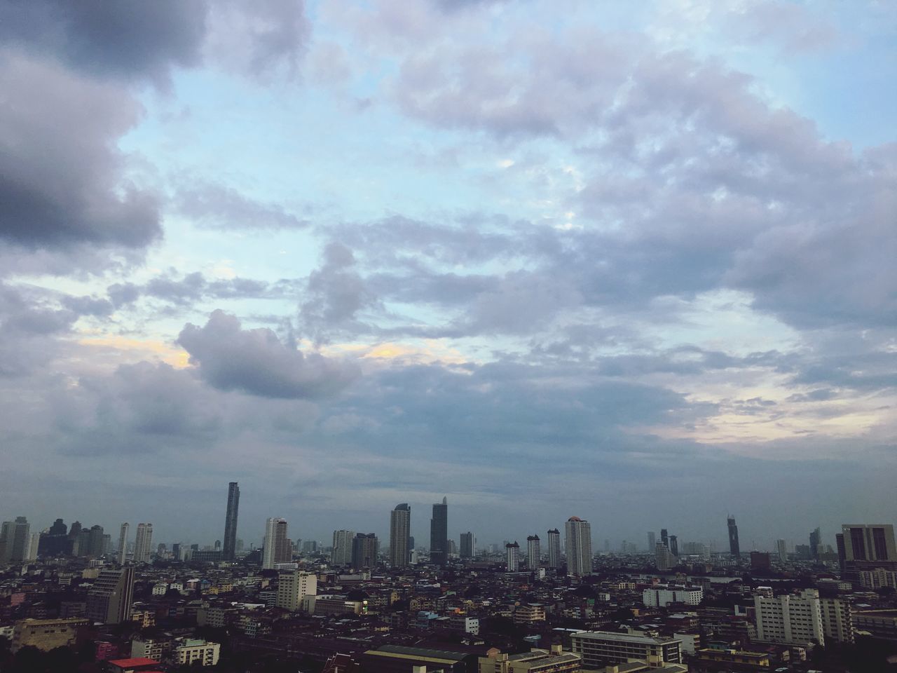 AERIAL VIEW OF BUILDINGS AGAINST SKY IN CITY