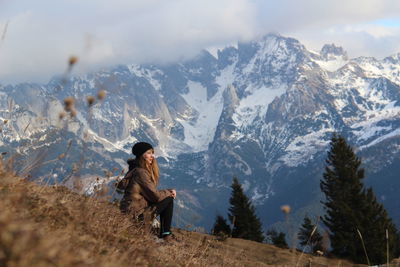 Woman standing on snow covered landscape