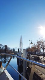 Bridge over river in city against clear sky