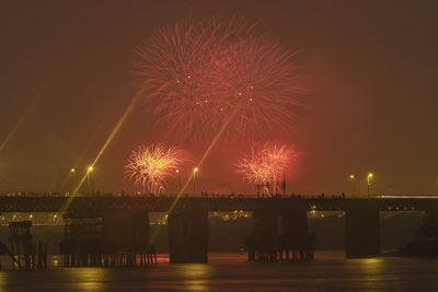 Low angle view of firework display at night