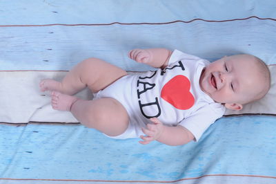 High angle view of baby lying on swimming pool