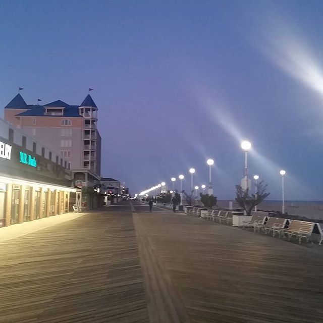 built structure, architecture, the way forward, building exterior, illuminated, street light, sky, lighting equipment, diminishing perspective, empty, railing, night, blue, clear sky, city, incidental people, walkway, outdoors, copy space, vanishing point