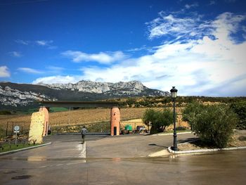 Road by mountain against sky