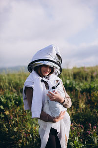 Portrait of woman standing on land against sky