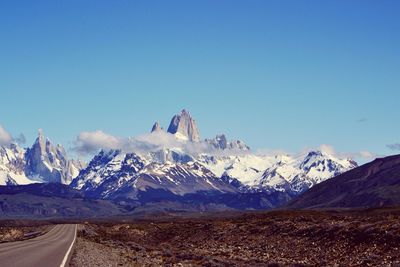 Scenic view of mountains against clear blue sky