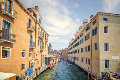 Canal amidst buildings in city