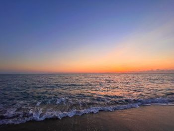 Scenic view of sea against clear sky during sunset