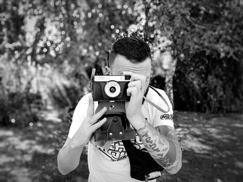 Portrait of man photographing camera