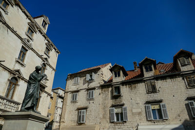 Low angle view of buildings against blue sky