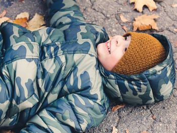 Smiling cute boy lying on field