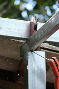 Close-up of clothespins hanging on railing