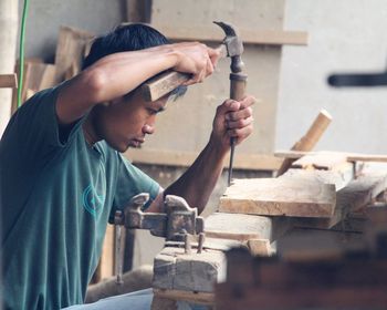 Midsection of man working at workshop