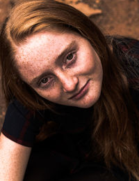 Beautiful redheaded girl with freckles looking up