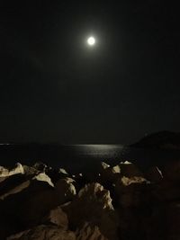 Scenic view of sea against sky at night