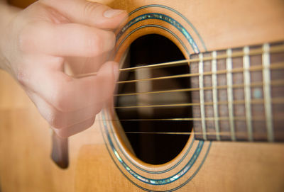 Cropped image of hand playing guitar