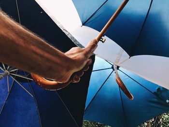 Cropped image of hand holding umbrella