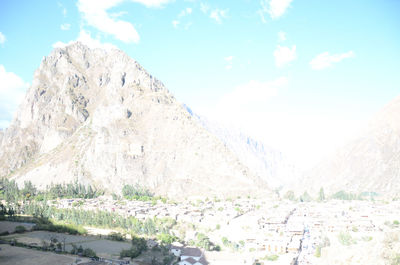 Scenic view of mountains against cloudy sky