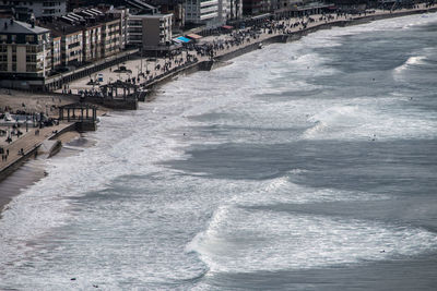 Sea by buildings in city