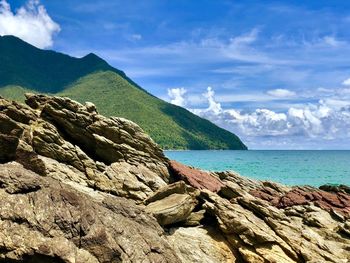 Scenic view of sea and mountains against sky