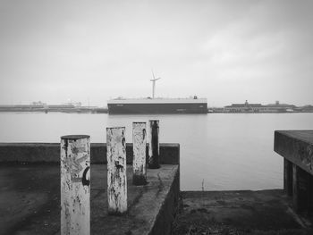 Commercial dock by sea against sky