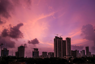 Silhouette buildings against sky during sunset