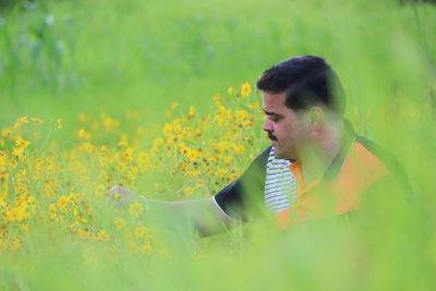 Man looking at flowers in farm