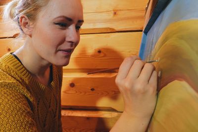 Close-up of young woman painting