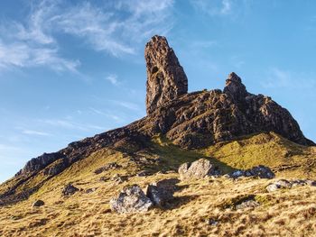 Low angle view of rock against sky