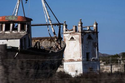 Low angle view of built structure against clear blue sky