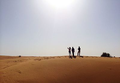 Man in desert against clear sky