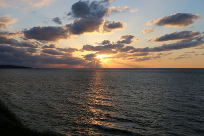 View of sea against cloudy sky during sunset