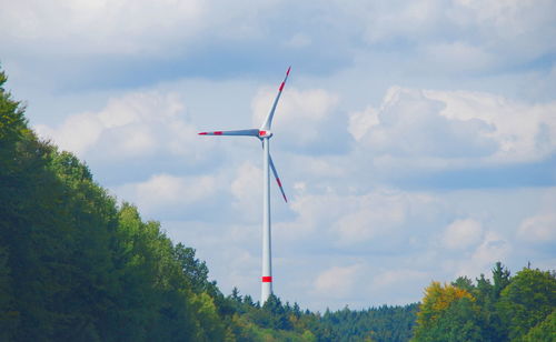 Low angle view of windmill against sky