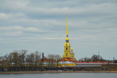 View of communications tower against cloudy sky