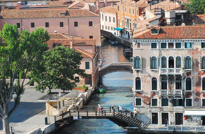 High angle view of canal amidst buildings in city