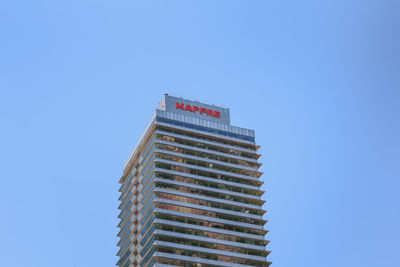 Low angle view of modern building against clear blue sky