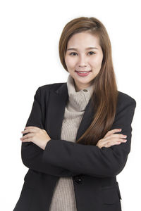 Portrait of young woman against white background
