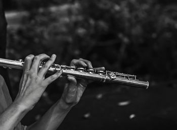 Cropped hands playing flute