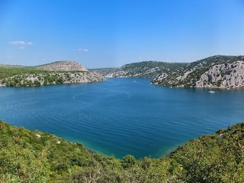 Scenic view of sea against clear blue sky