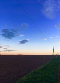 Scenic view of field against sky during sunset