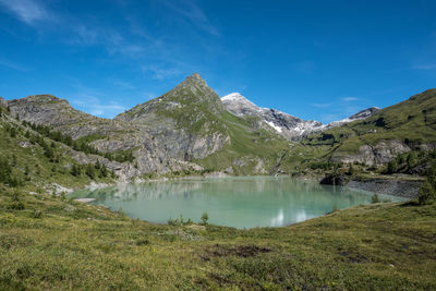 Scenic view of lake and mountains against sky