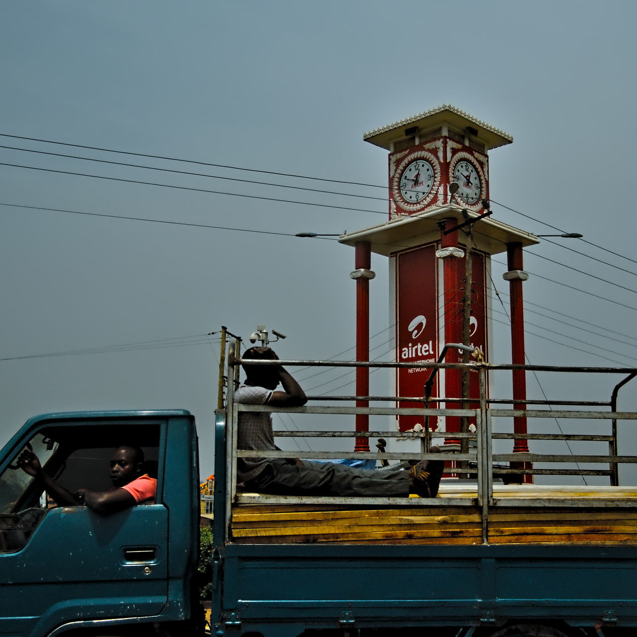 mode of transportation, transportation, sky, land vehicle, nature, motor vehicle, day, car, cable, real people, low angle view, occupation, men, outdoors, travel, architecture, technology, people, built structure