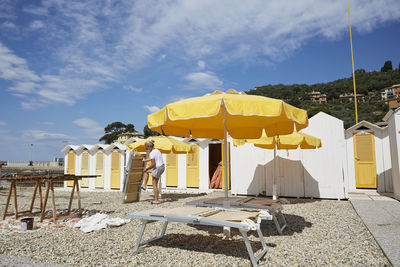 Parasols on beach against sky