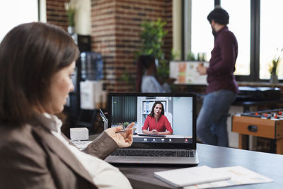 Businesswoman doing video call on laptop