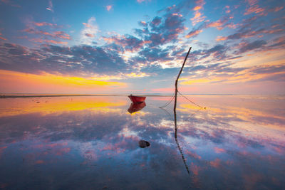 Scenic view of boat at river during sunset