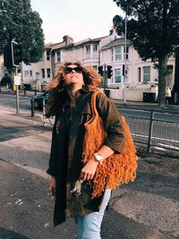 Woman standing on street in city